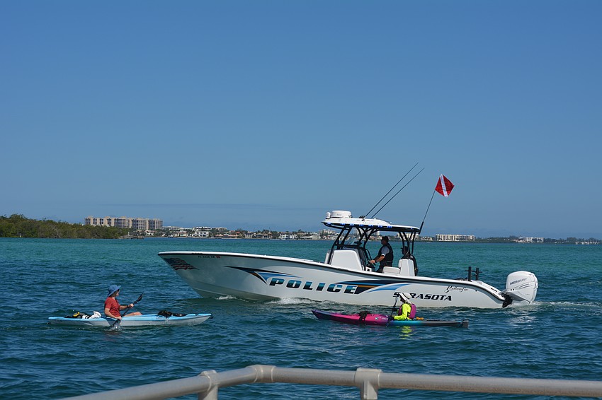 Volunteer kayakers and police patrol