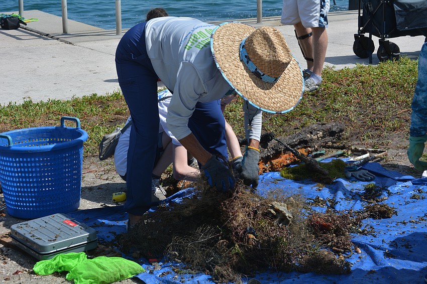 Ronda Ryan, executive director, sorts the debris from the cleanup.