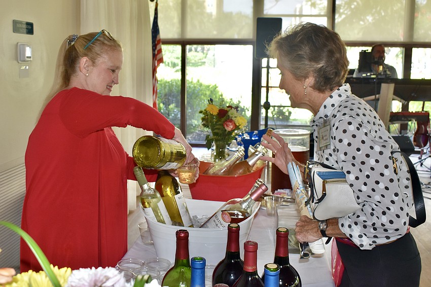 President Kelly Goodwin pours a drink for Sarah Munford.