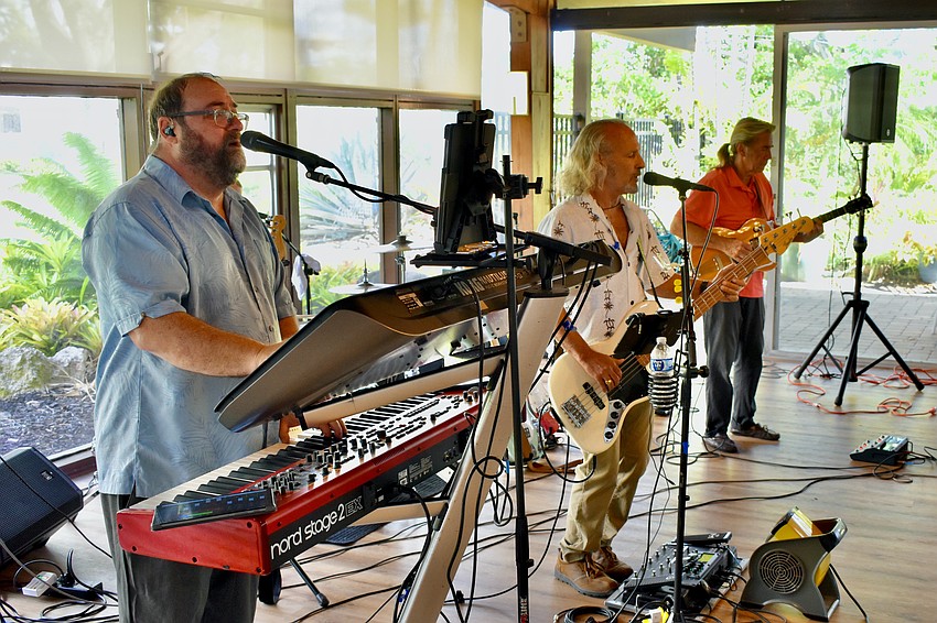 Mark Greenberg, Lei Stanhoe, and Bill Hint of The JAM perform for the guests.