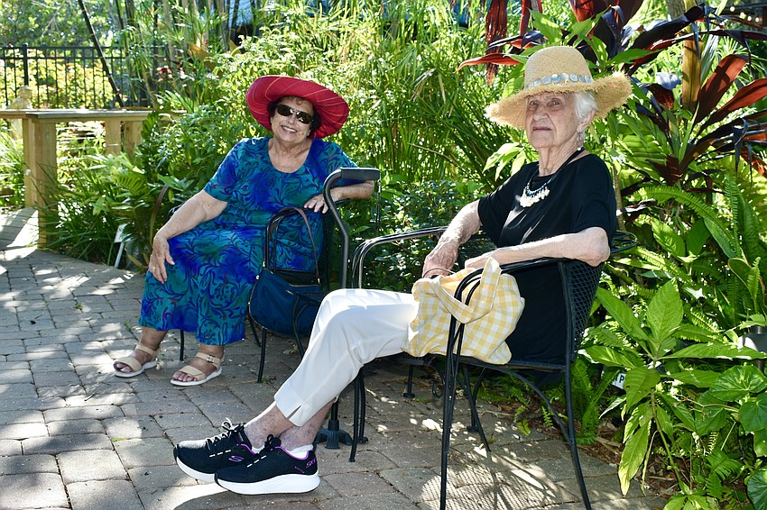 Mary Strain and Jo Brown relax in the garden.