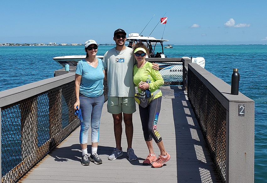 Linda Wolfe, Christopher Comas and Wendi Gengler volunteered to assist with cleanup efforts at the Sarasota Bay.