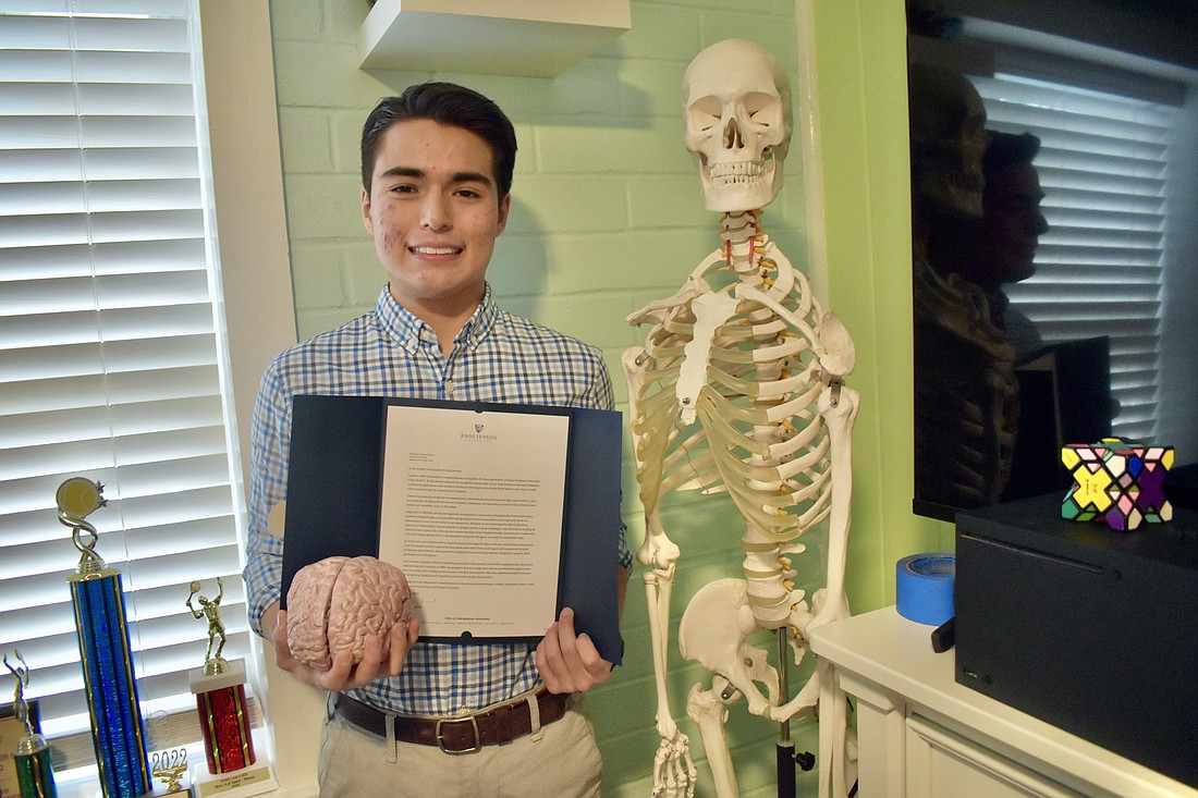 Alejandro Peralta holds a letter of acceptance from Johns Hopkins University.