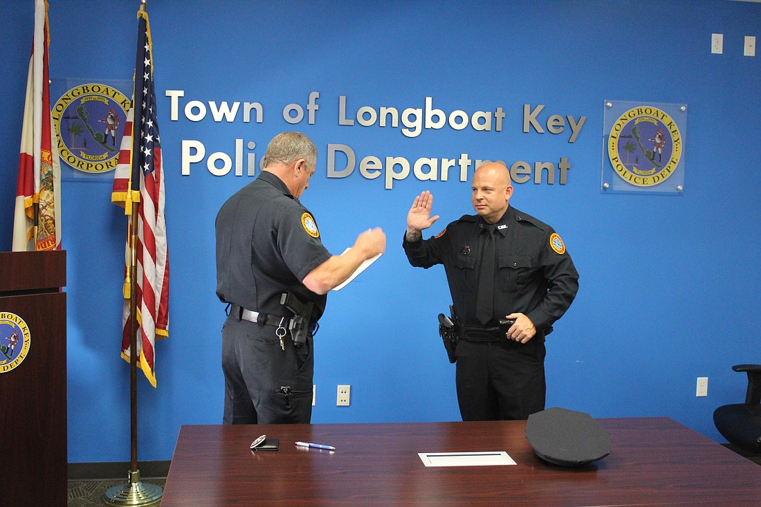 Longboat Key Police Department's newest officer Justin Ramsaier (right) was sworn in on June 2.