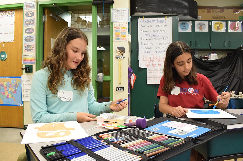 Elizabetta Morar, a rising sixth grader at Buffalo Creek Middle School, paints the Lorax while Emma Duarte, a rising sixth grader at Carlos E. Haile Middle School, paints Goo from 