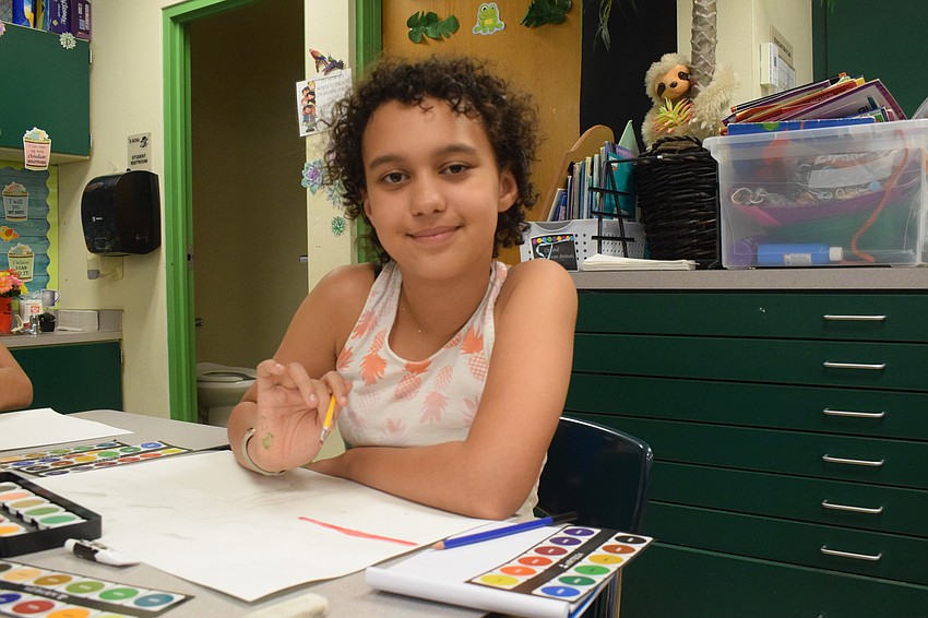 Joleisa Simons, a rising seventh grader at Dr. Mona Jain Middle School, works on painting the sky.