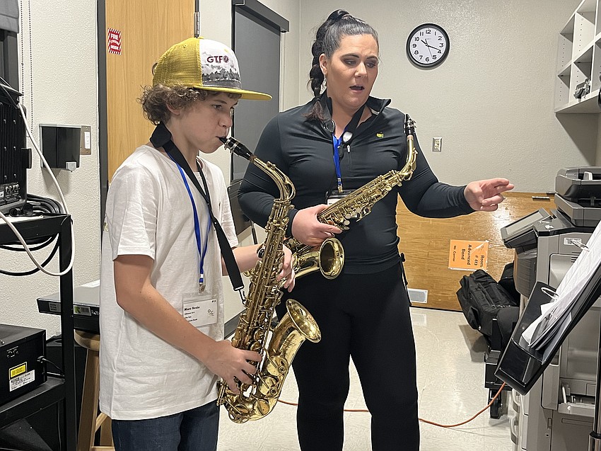 Marc Besio, a rising eighth grader at Louise R. Johnson K-8 School of International Studies, works one-on-one with Andrea Vella, the band director at Southeast High School.