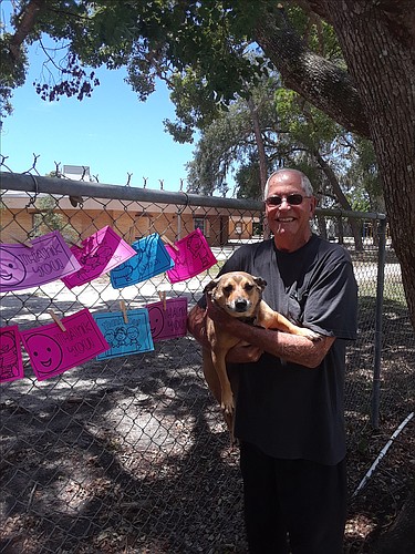 Ron Dick, pictured with his dog Dixie, said he will miss the kids while their school is being rebuilt. Courtesy photo