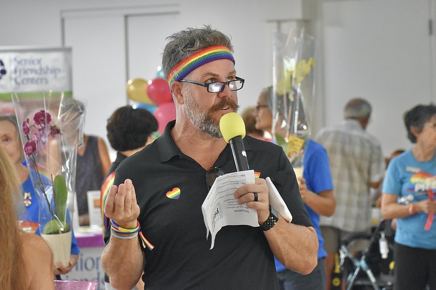 Jason Champion, president of Project Pride, makes an announcement.