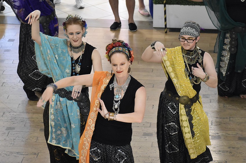 Belly dancers Elizabeth Hall, Stephanie Rischard, and Seth Grayson, of ShimmyBOOM Tribal Bellydance Troupe, perform at the event.