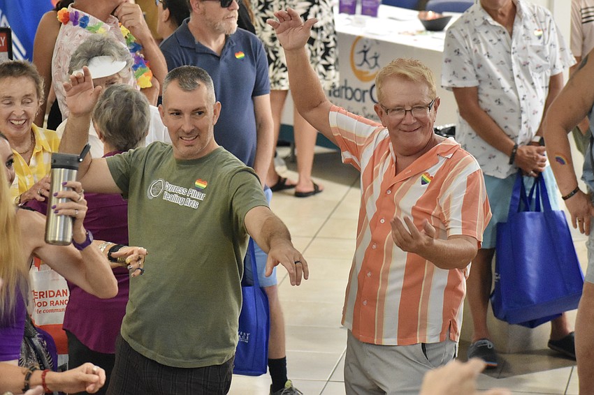 Dr. Brian Nell of Cypress Pillar Healing Arts, and Bob Hinsley, dance along with ShimmyBOOM Tribal Bellydance Troupe.