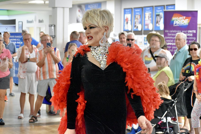 Drag performer Dame Lindsay Carlton-Cline sings at the event.