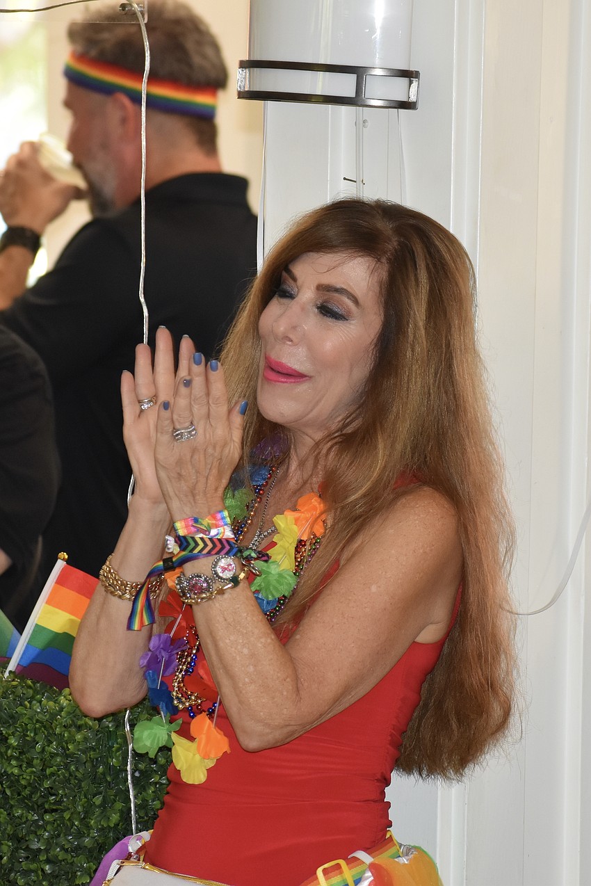 Senior Friendship Centers volunteer Dava Guerin applauds a performance.