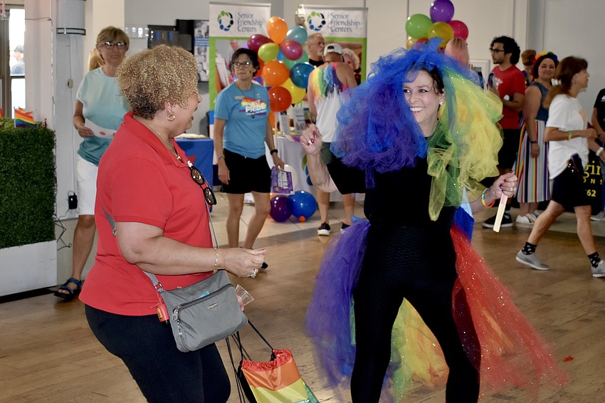 AARP employee Tye Hausheer dances with Trudy Garrett.