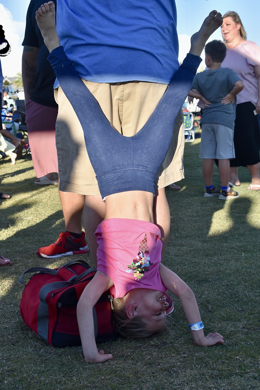 Lakewood Ranch resident Frances Kozma does a headstand with a little help from her dad, Abe.