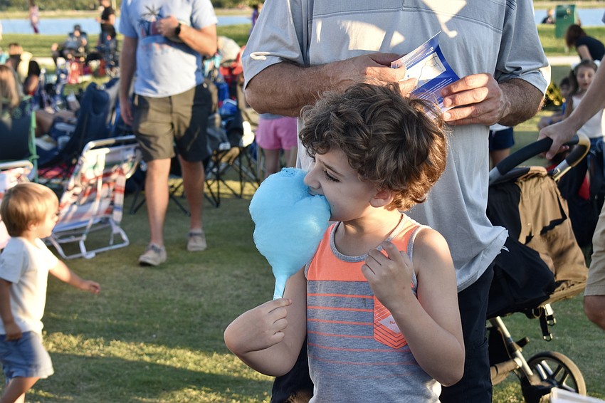 Palmer Ranch resident Kyle Tomlin eats cotton candy before checking out the Mote exhibit.