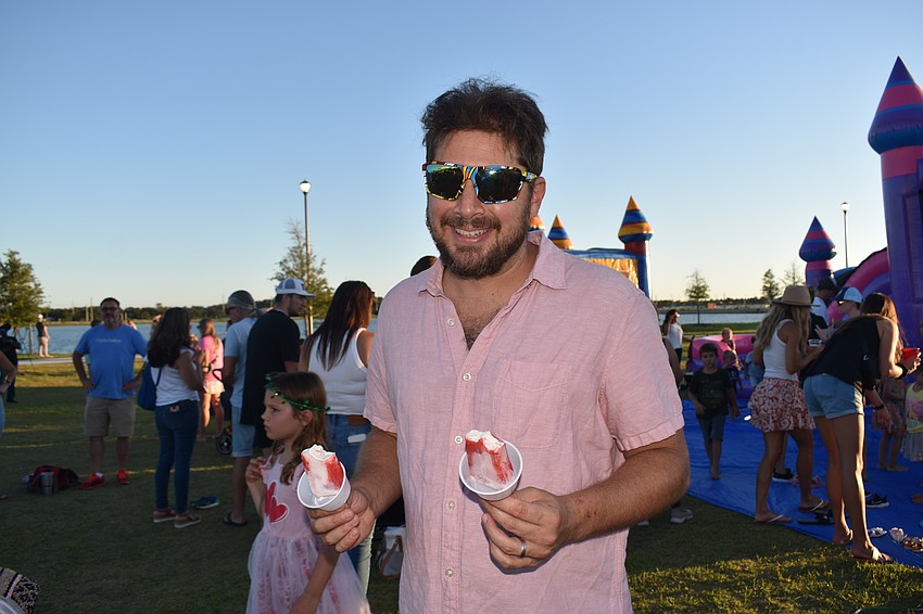 Benjamin Craig ends up double-fisted with ice pops after his kids didn't like the strawberry cheesecake flavor.