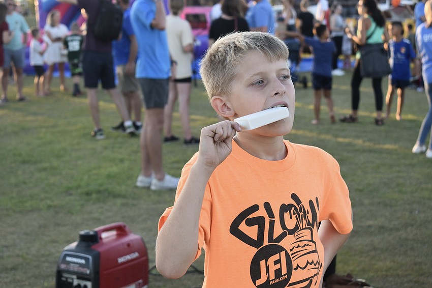 Sarasota resident Liam Rielmann enjoys a coconut cream ice pop.