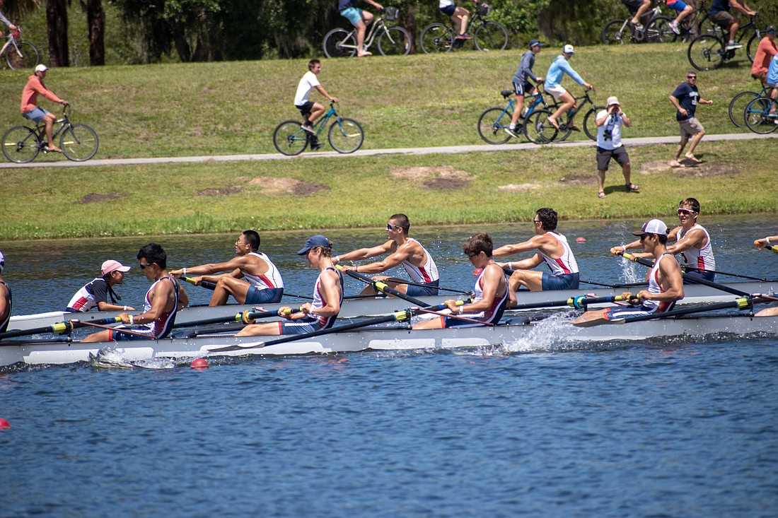 The Sarasota Crew U17 men's 8+ boat (back) rows ahead of the RowAmerica Rye boat at the 2023 Youth Nationals.