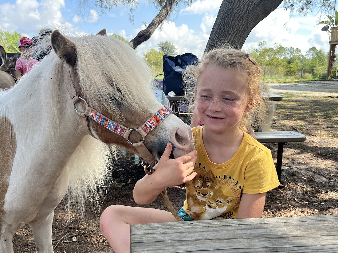 Asher shows 7-year-old Claire Pies some love.