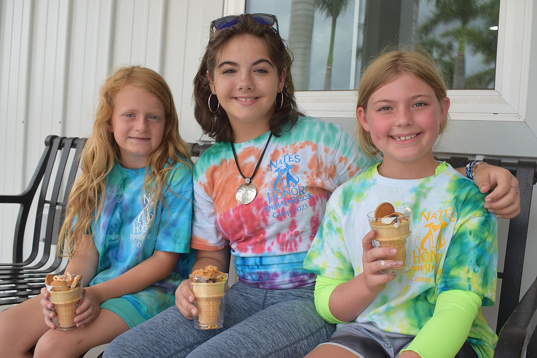 Hadley Chadwick, Mia Wolcott and Betsy Rohel make frozen treats for their four-legged friends.