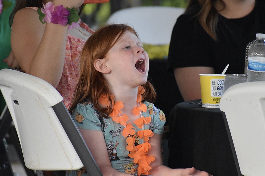 5-year-old Bennett Maryott cheers on her father Andrew Maryott as he is called up to the dance floor to accompany the dancers.