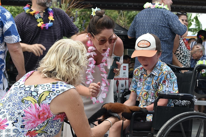 Nancy Nallin introduces Kim Carson and 10-year-old Wyatt Carson to one of the new young lemur residents.