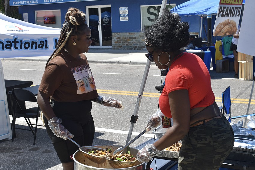 Eboni Rainey-Haynes and Jasmine Jackson cook up some offerings at the Boiled Peanuts stand.