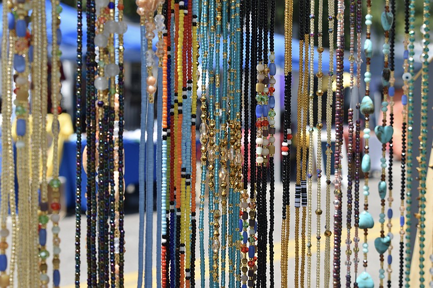 Beads hang on display at the Waist Beads stand.