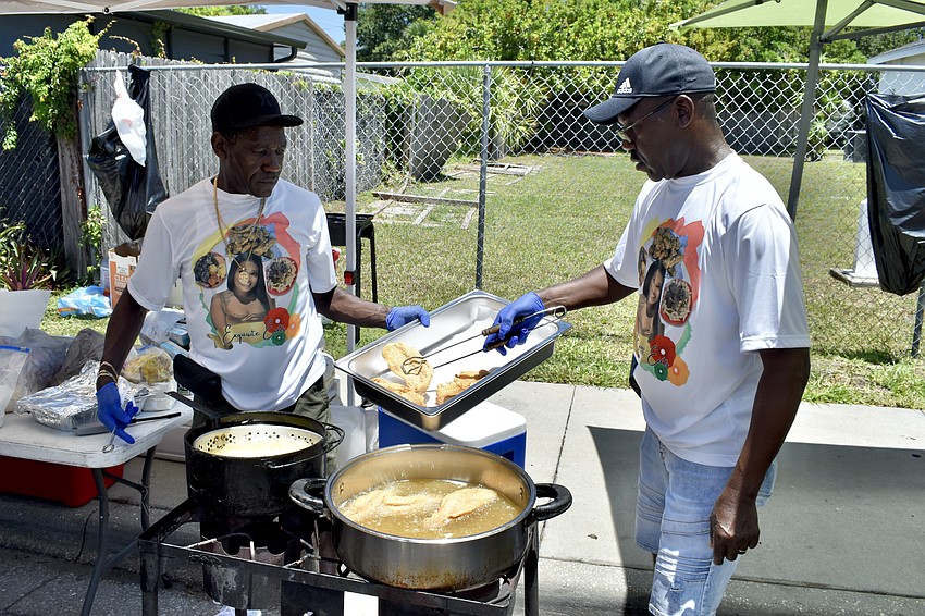 Mike and Robert Stafford fry fish at Exquisite Eats.