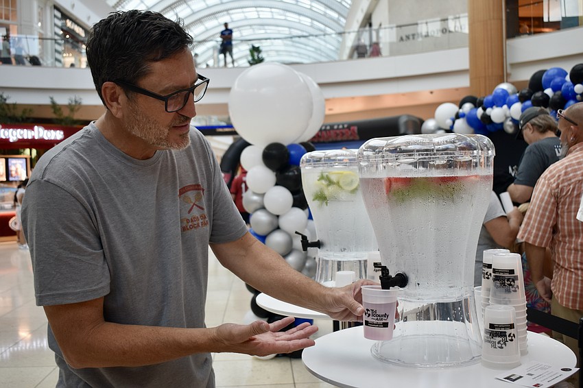 Rich Hart of Tri County Air Conditioning & Heating impresses the kids with color changing cups. Tri County sponsored the block party.