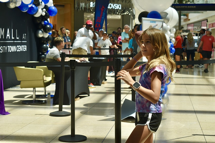 Bradenton resident Autumn Daugherty takes a shot at the inflatable goal post set up by the Tampa Bay Buccaneers for the Dad's Day Block Party.
