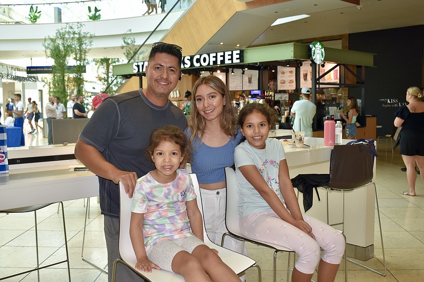 Sarasota residents Gustavo, Lea, Gia and Astrid Bustamante finish up some Häagen-Dazs ice cream and head back to the block party.