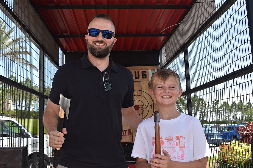 Venice residents Chase and Tyson Brown pick up ax throwing quickly. The first-timers each hit a bullseye.