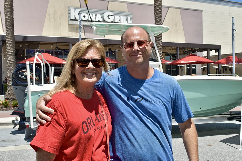 Sarasota residents Jackie Williams and Josh Friedl sign their waivers and wait their turn to get into the Axe Haus to try ax throwing for the first time.