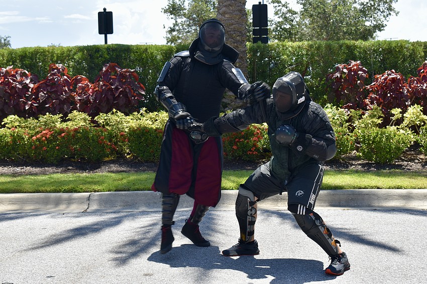 Avery Fuller and Chris Fontana demonstrate historical European sword fighting for the Steel Ring Academy.