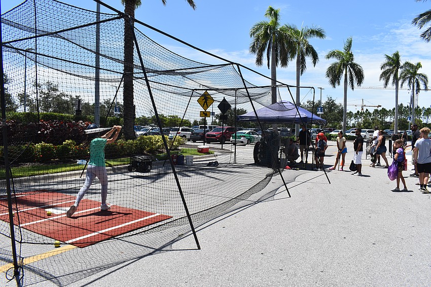 Batting and ax throwing are the main activities outside at the Dad's Day Block Party.