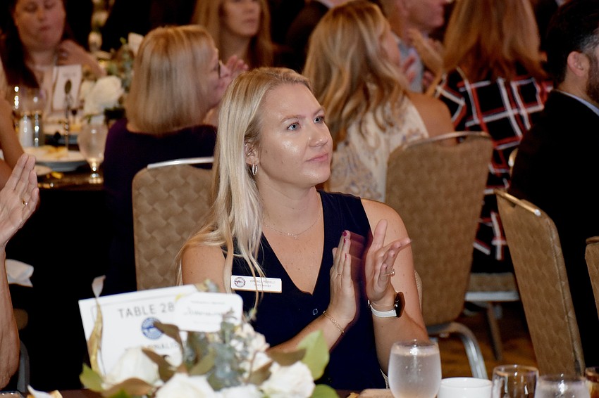 Mote Marine Laboratory events manager Veronica Perrelli applauds a speaker.