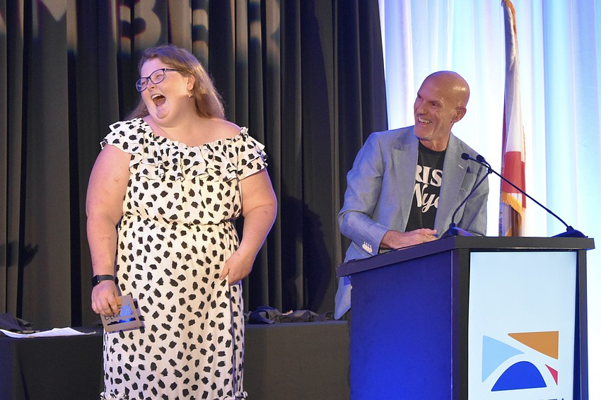 Rye's and Nye's employee Mary Russell laughs at a story told by co-founder Beaver Shriver.