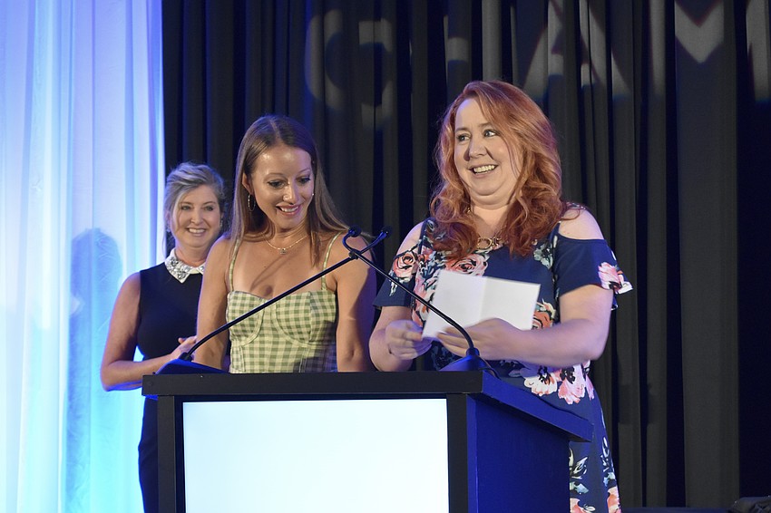 Greater Sarasota Chamber of Commerce president and CEO Heather Kasten, Stage Door Studios director Geena Larson, and owner Jill Athridge celebrate Stage Door Studios receiving the Woman