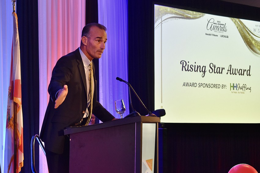 Darrin Rohr, president of HH Staffing, presents the Rising Star Award.