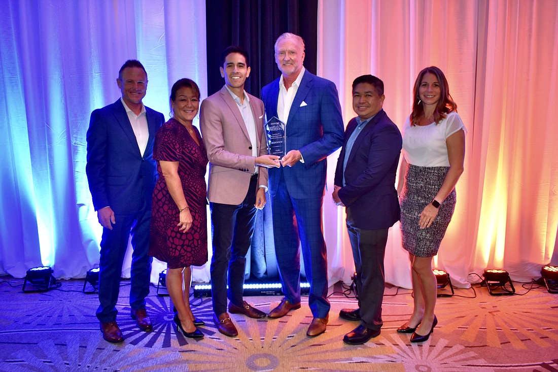 Workforce Development & Innovation award with PGT Innovation staff Rob Moulds, Debbie LaPinska, Lakewood Ranch Medical Center chief operating officer Diego Perilla, and PGT Innovation staff Jeff Jackson, Don Vichitvongsa, and Stephanie Cz.