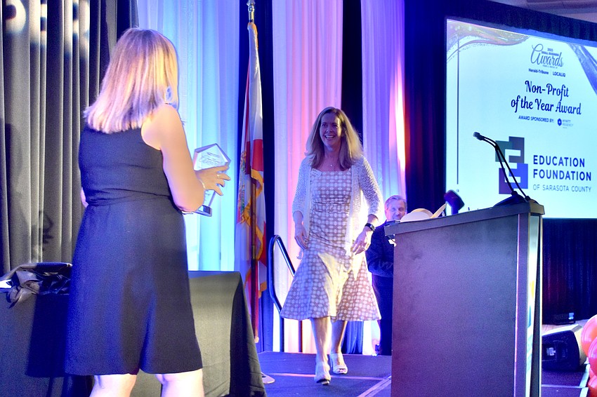 Hyatt Regency Sarasota director of events Carol Danisi presents the Non-Profit of the Year Award to Education Foundation of Sarasota County president and CEO Jennifer Vigne