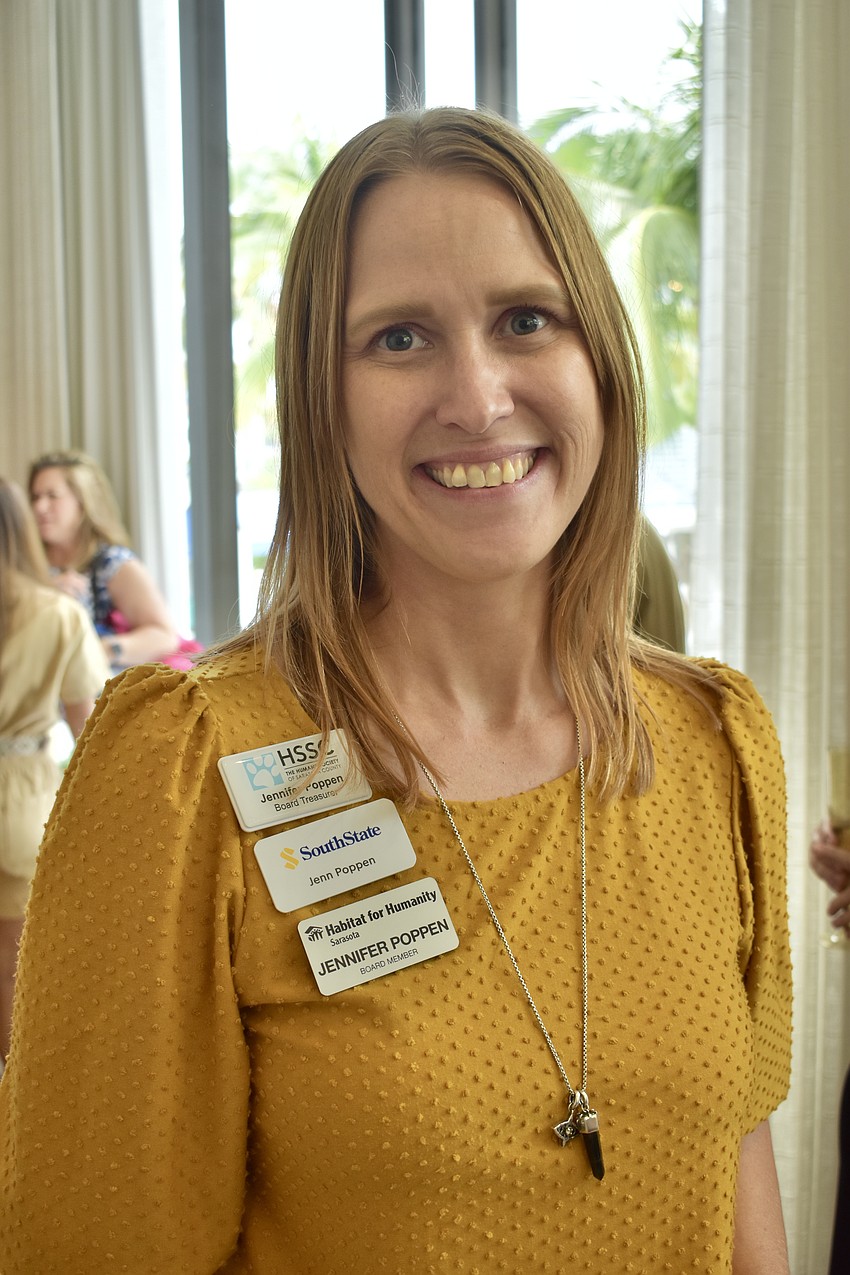 Jennifer Poppen showed her community involvement through different name badges.