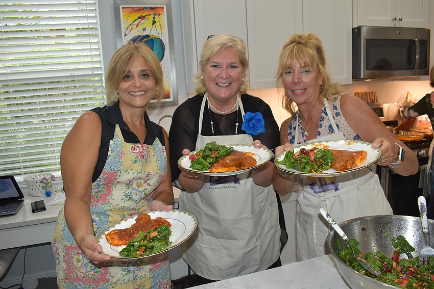 Parrish's Graceann Frederico, Lakewood Ranch's Maribeth Phillips, and Sarasota's Roxanne Sima show off the goods before sitting down to eat.