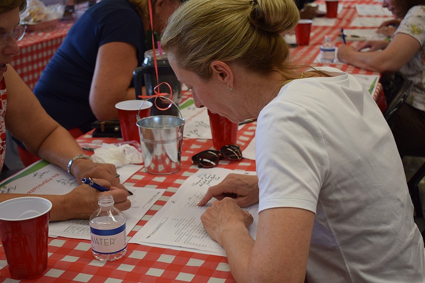 Commissioner Debra Williams works hard to finish the Longboat-themed crossword puzzle.