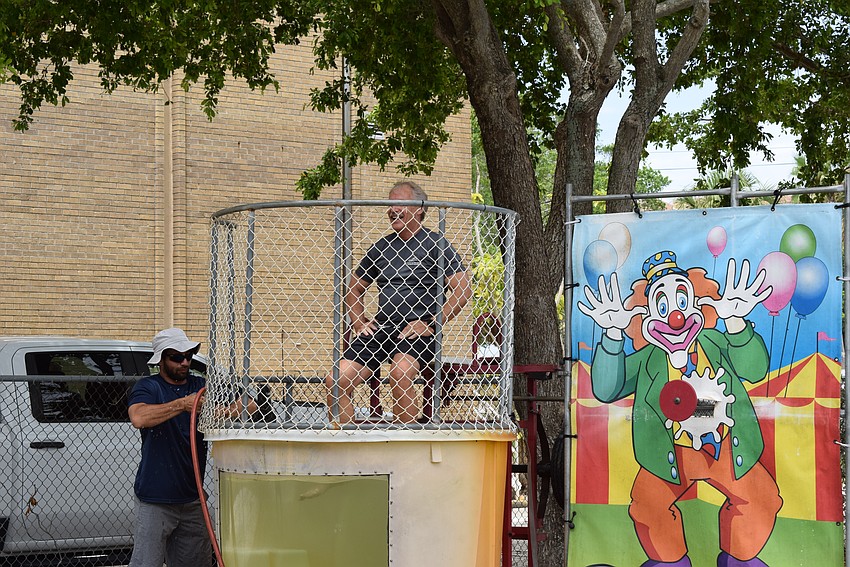 Town Manager Howard Tipton gets settled in the dunk tank before employees line up to try to get the perfect shot.