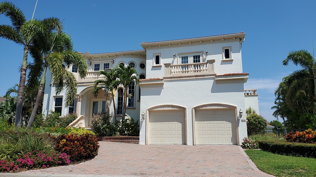 This $4.1 million Country Club Shores home located at 572 Halyard on Longboat Key has four bedrooms, five-and-a-half baths, a pool and 4,682 square feet living area.