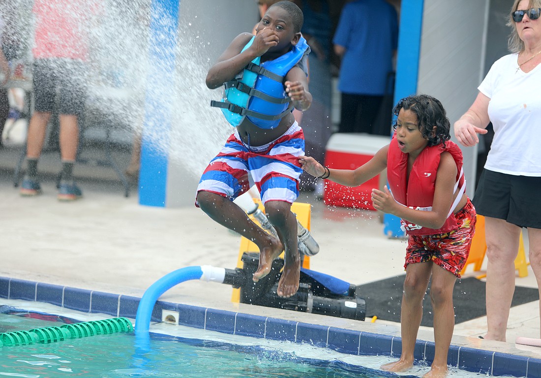 Kaiden Smith and Braily Guterrez take a dip at the Belle Terre Swim and Racquet Club open house on June 25, 2023. File photo by Brent Woronoff