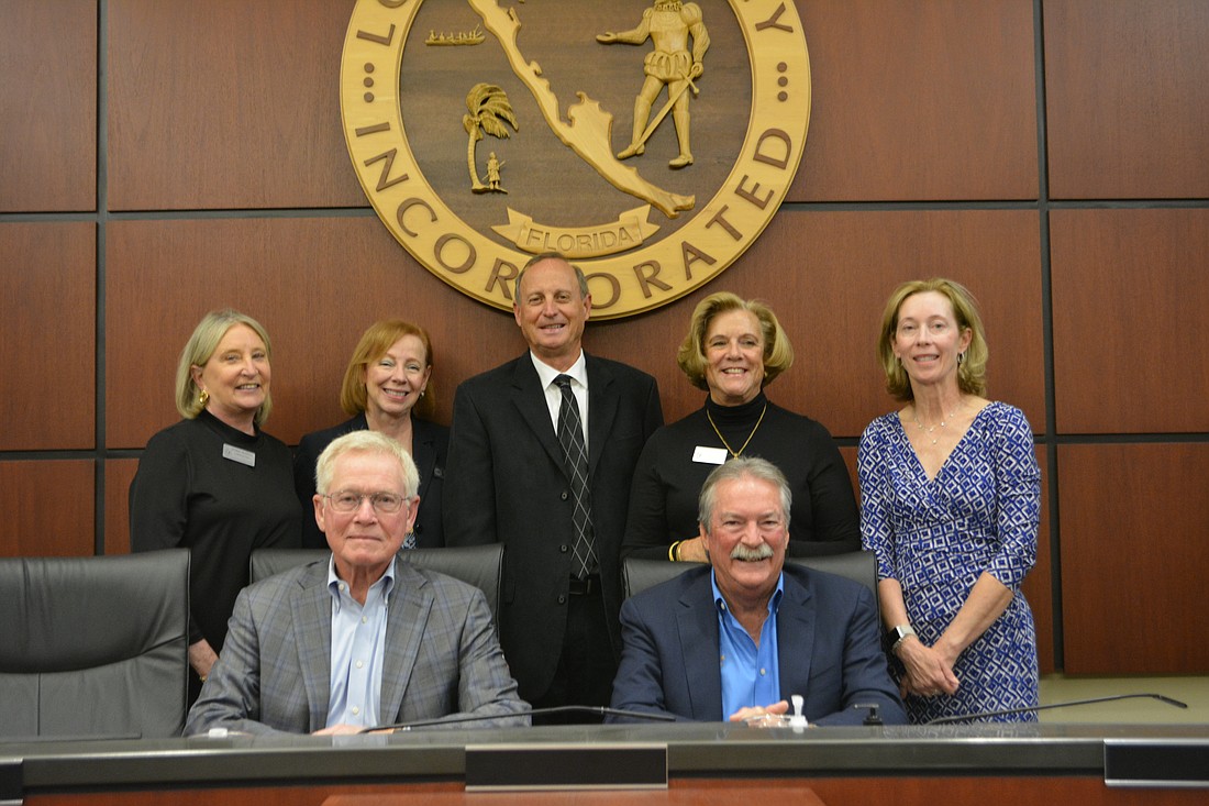 Commissioners Deborah Murphy (beck left) and Gary Coffin (back center) were sworn in on March 20. Also pictured: Penny Gold, BJ Bishop, Debra Williams, Mayor Ken Schneier and Vice Mayor Mike Haycock.